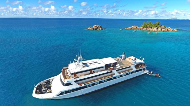 seyhelles yacht from front with tiny island in the background