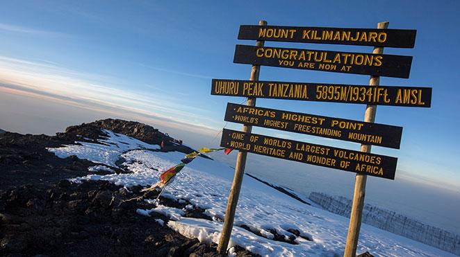mount kilimanjaro summit sign at sunrise